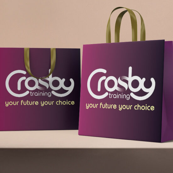 Two stylish burgundy get bags with Crosby Training logos and gold handles.