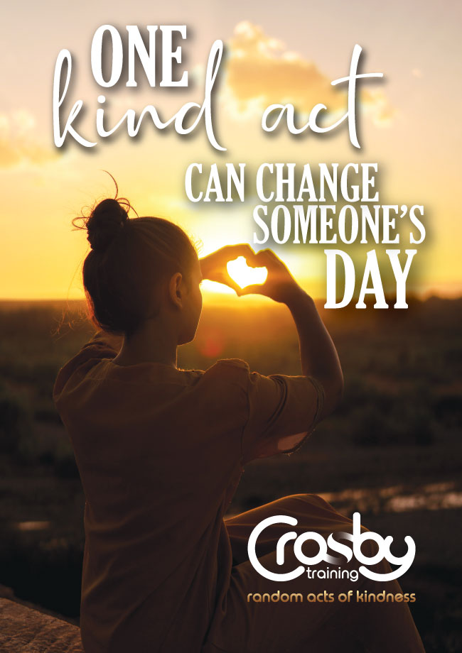 A woman makes a heart shape with her hands against a bright yellow sunset, accompanied by the text 'One kind act can change someone's day'' and 'Crosby Training random acts of kindness'.