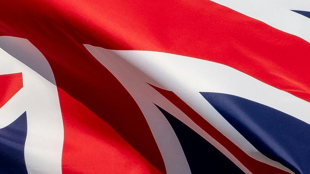 A close-up of a Union Jack flag waving in the wind.