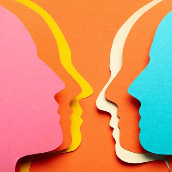 A graphic of layered paper head silhouettes in pink, blue and yellow, facing each other on an orange background, representing communication.