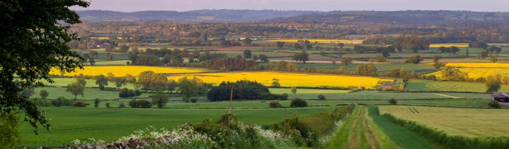 A panoramic view of the English countryside featuring rolling green hills.
