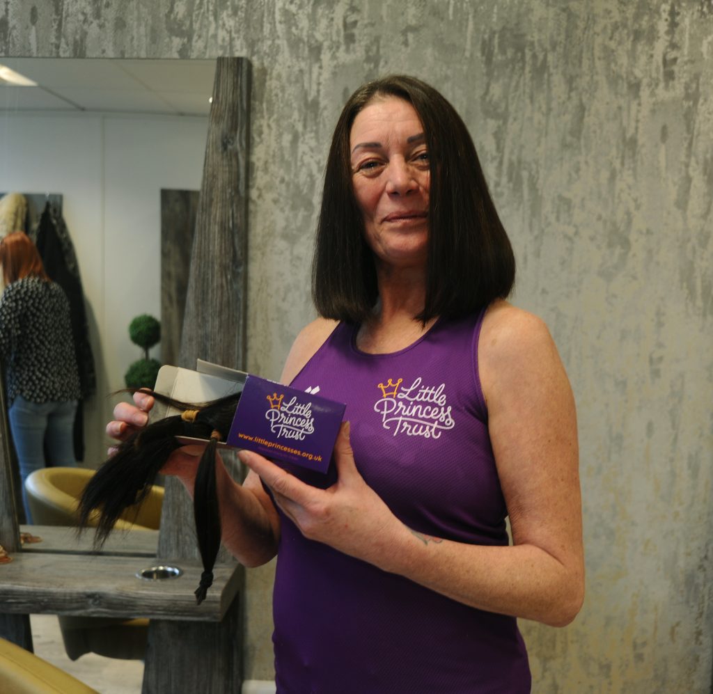 Learner displaying hair donated to the Little Princess Trust charity.