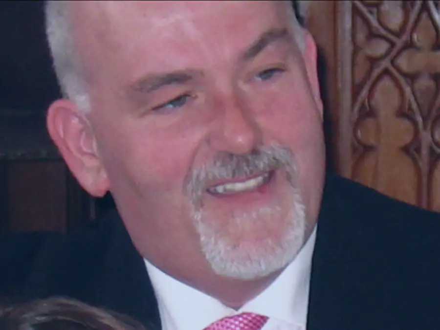 Colin, looking very dapper in suit and tie with a stylish (and grey!) goatee and moustache.