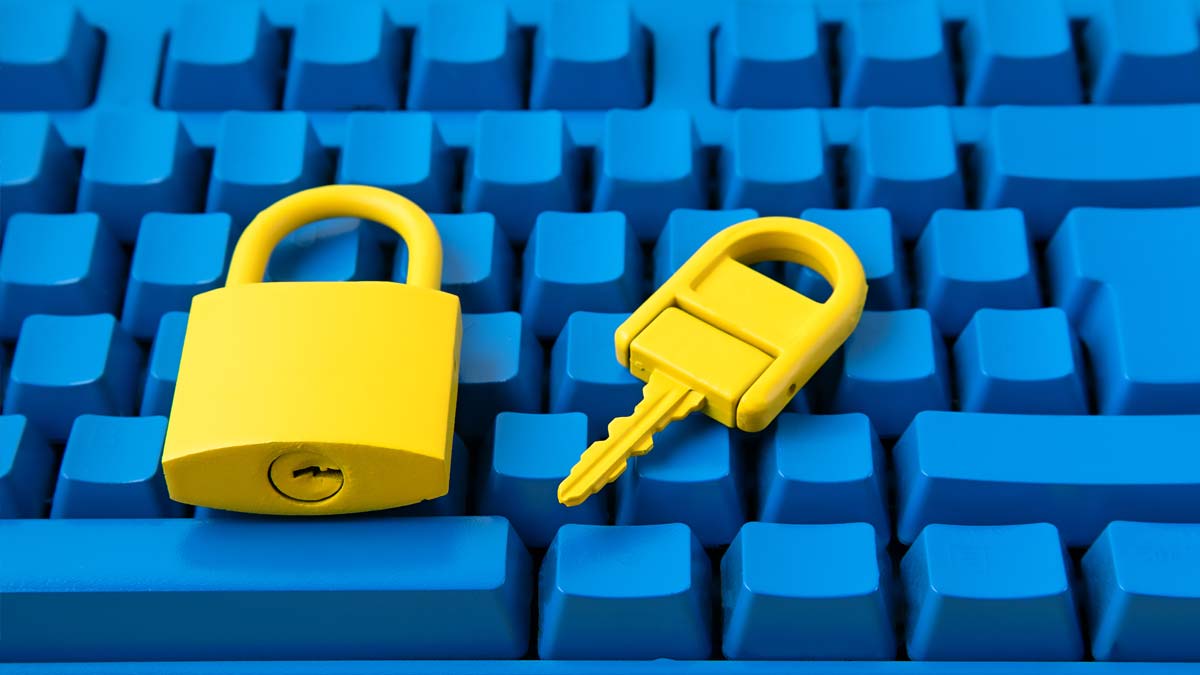 A blue computer keyboard with a yellow padlock and key placed on top.