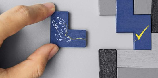 A hand moving the Matrix logo into place as part of a larger jigsaw puzzle.