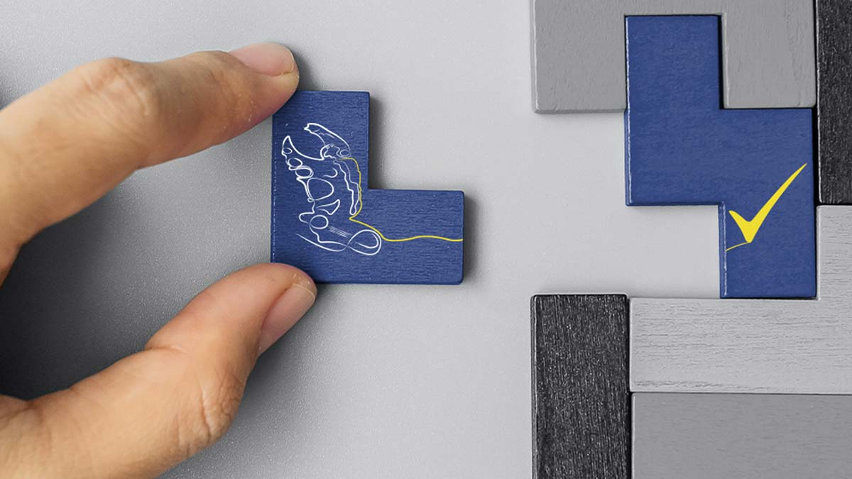 A hand moving the Matrix logo into place as part of a larger jigsaw puzzle.