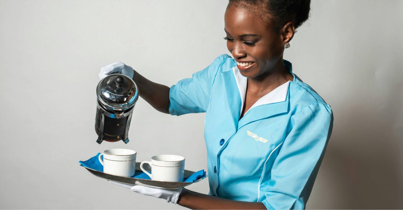 Air hostess pours coffee into cups