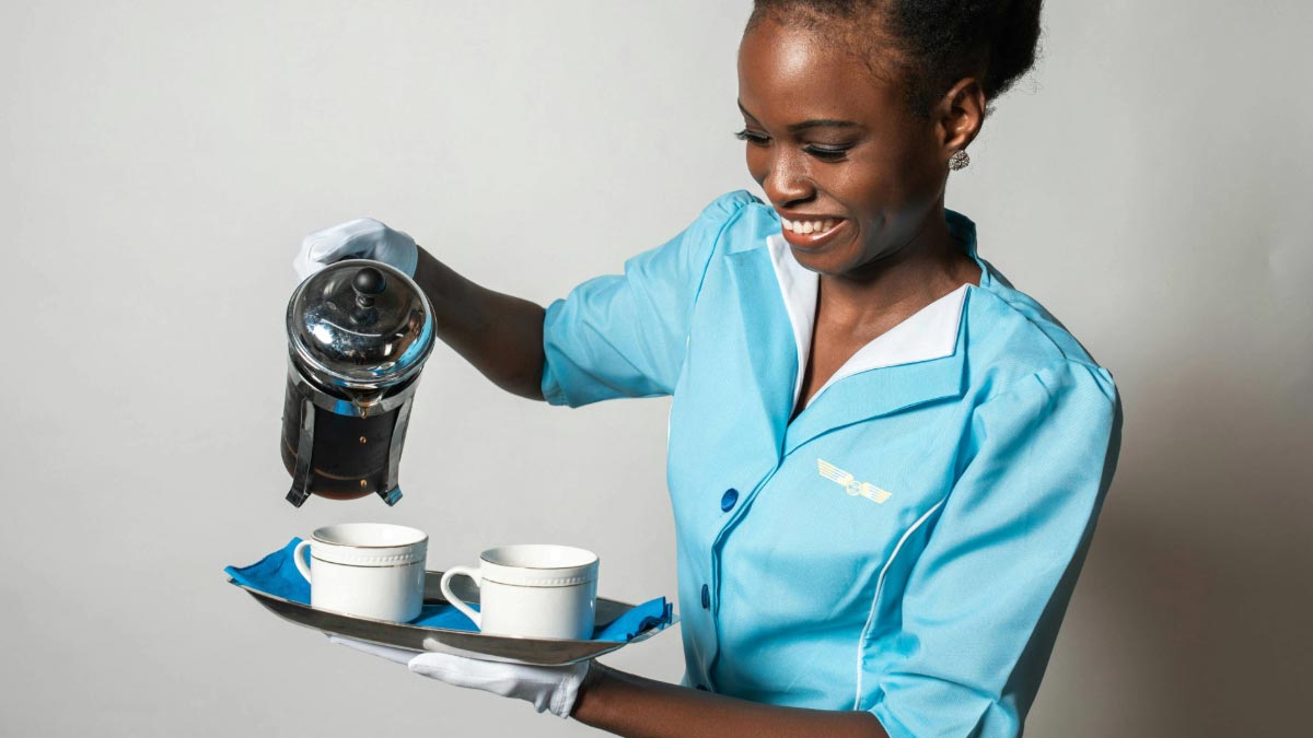 Air hostess pours coffee into cups