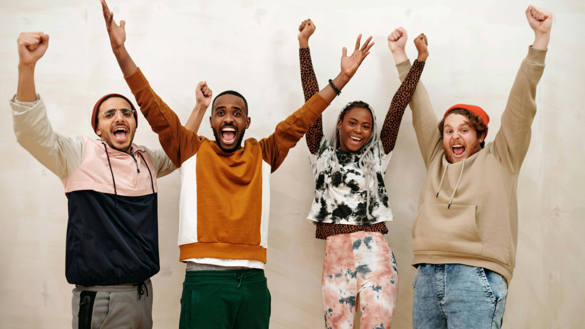 Learners celebrating with hands aloft