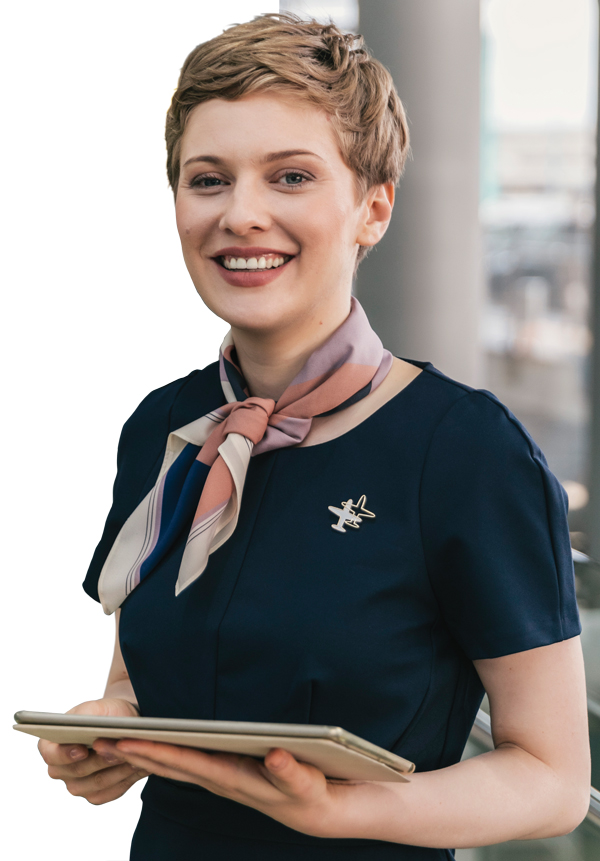 A female airport worker holding a computer tablet.